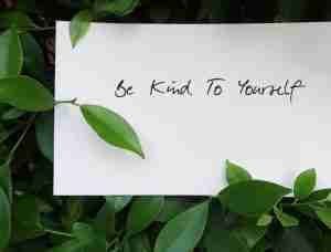 Handwritten,Paper,On,Green,Plant,Background,Be,Kind,To,Yourself,